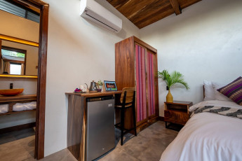 Jacaranda - Half a bed, closet and full desk view